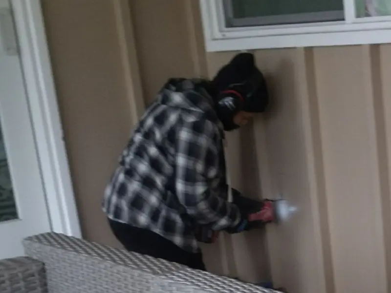 Professional electrician installing an exterior outlet in Fish Hawk